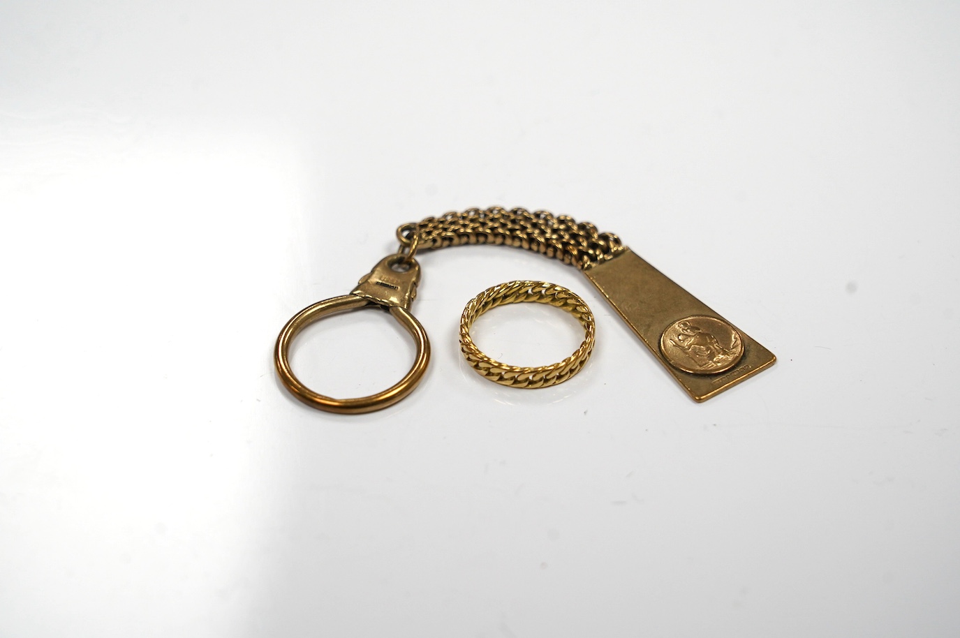 A 9ct gold key chain, with engraved inscription and a yellow metal band, gross weight 17.2 grams. Condition - fair